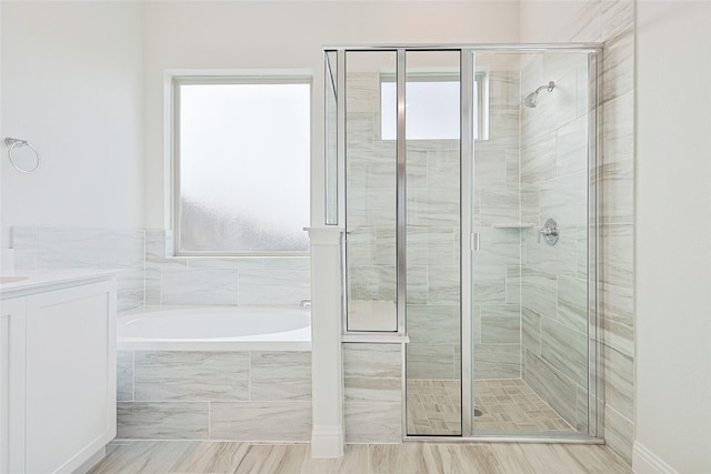 bathroom with plenty of natural light, vanity, and plus walk in shower