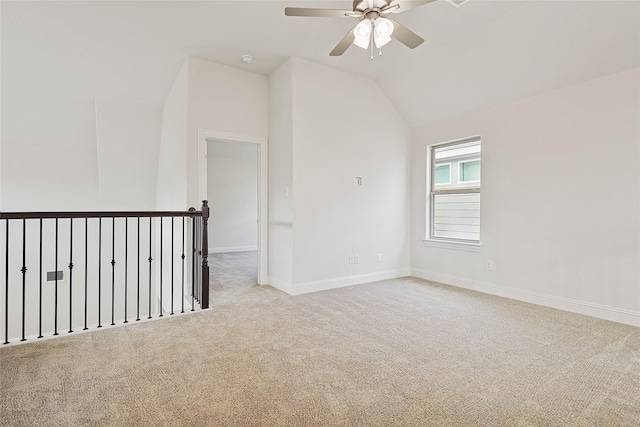 carpeted empty room with ceiling fan and lofted ceiling