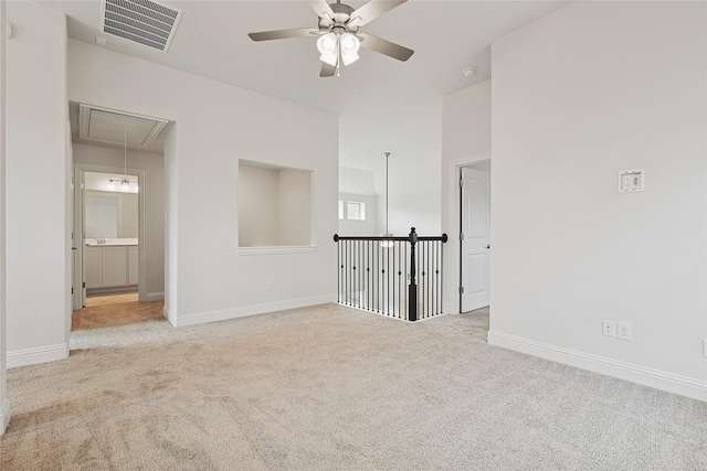 carpeted spare room with ceiling fan