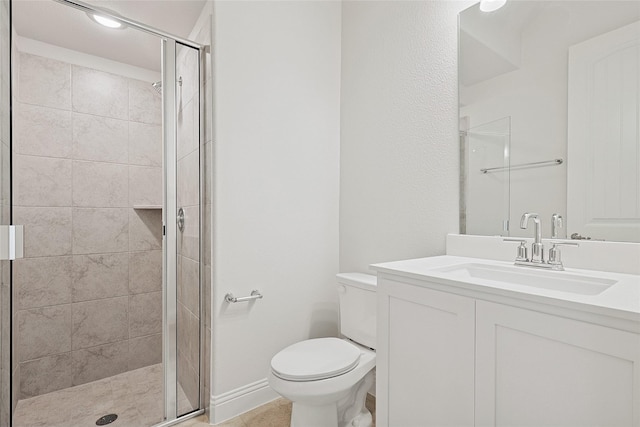 bathroom featuring vanity, toilet, and a shower with door