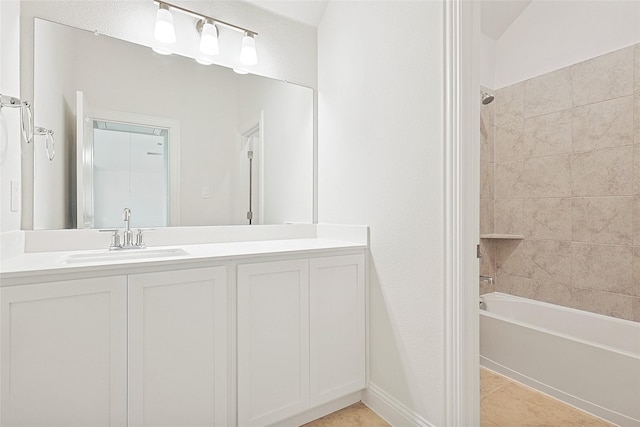 bathroom featuring vanity, tile patterned floors, and tiled shower / bath