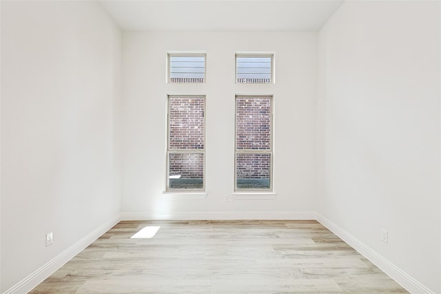 empty room with light hardwood / wood-style floors