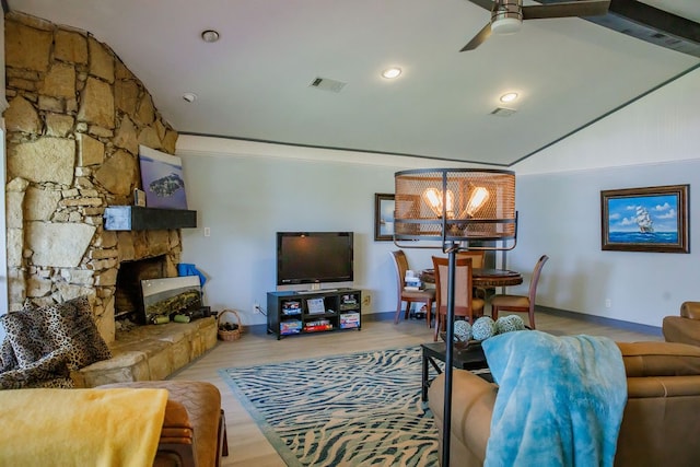 living room featuring ceiling fan with notable chandelier, a fireplace, wood-type flooring, crown molding, and lofted ceiling