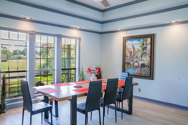 dining room featuring plenty of natural light, ornamental molding, and light wood-type flooring