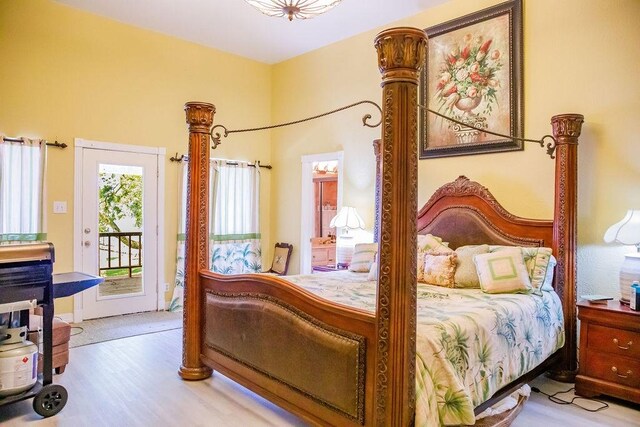 bedroom featuring access to exterior and light hardwood / wood-style floors