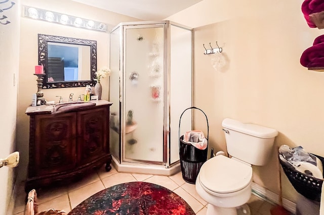 bathroom featuring vanity, toilet, tile patterned floors, and a shower with door