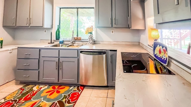 kitchen featuring dishwasher, sink, gray cabinets, black electric cooktop, and light tile patterned flooring