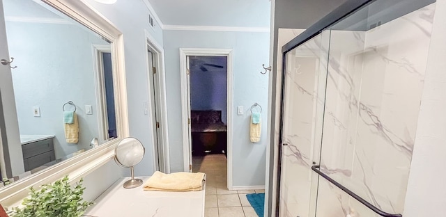 bathroom featuring a shower with door, vanity, ornamental molding, and tile patterned flooring