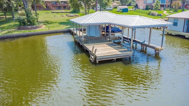 dock area featuring a water view and a yard