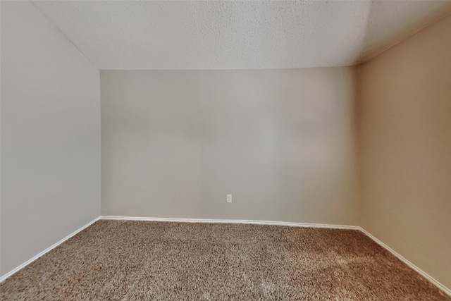 unfurnished room with a textured ceiling and carpet