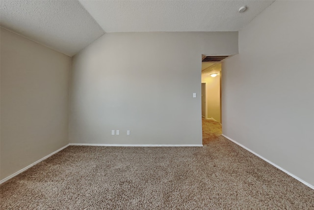 carpeted spare room with lofted ceiling and a textured ceiling