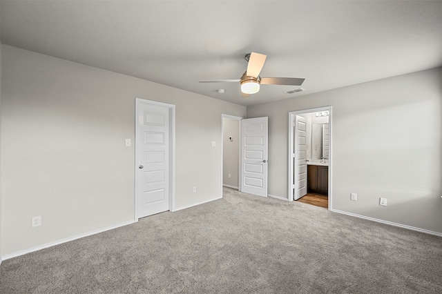 unfurnished bedroom featuring carpet flooring, ensuite bath, and ceiling fan