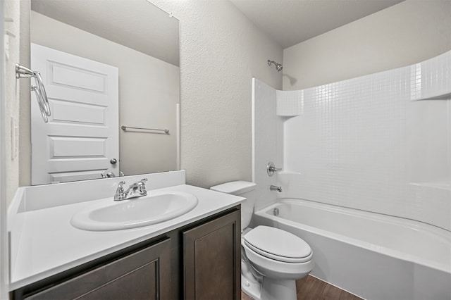 full bathroom featuring shower / bathtub combination, hardwood / wood-style floors, toilet, and vanity