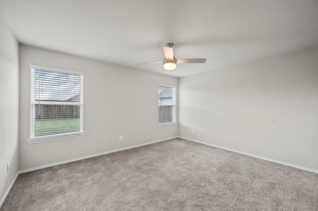 unfurnished room with ceiling fan and carpet flooring