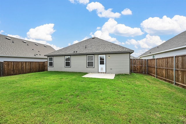 rear view of house with a patio area and a yard