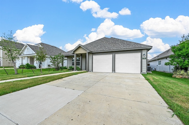 ranch-style home featuring a front lawn and a garage