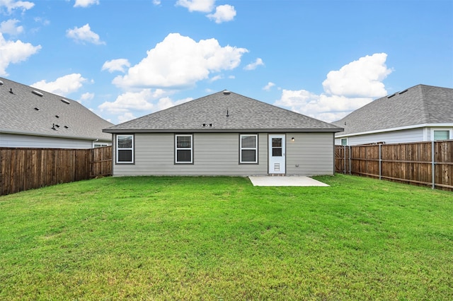 back of house with a lawn and a patio