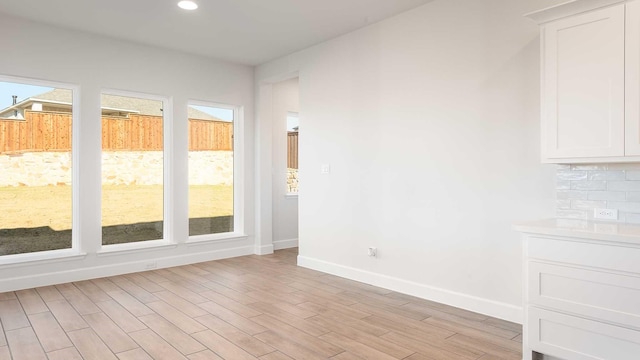 unfurnished dining area with plenty of natural light and light hardwood / wood-style flooring