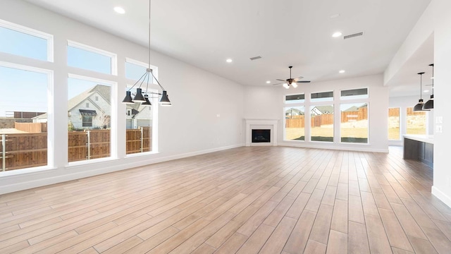 unfurnished living room featuring ceiling fan and light hardwood / wood-style flooring