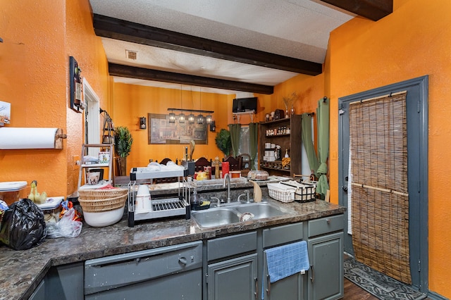 kitchen featuring gray cabinetry, dishwashing machine, sink, and beam ceiling