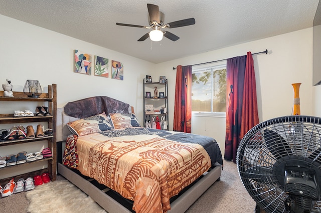 carpeted bedroom with a textured ceiling and ceiling fan