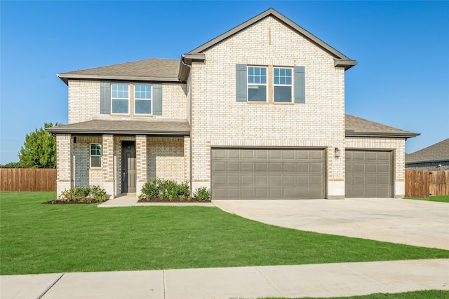 view of front of house featuring a garage and a front lawn