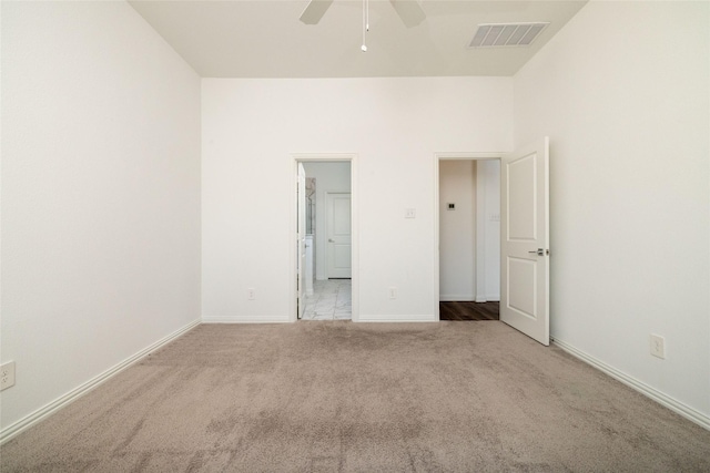 unfurnished bedroom featuring ceiling fan and light colored carpet