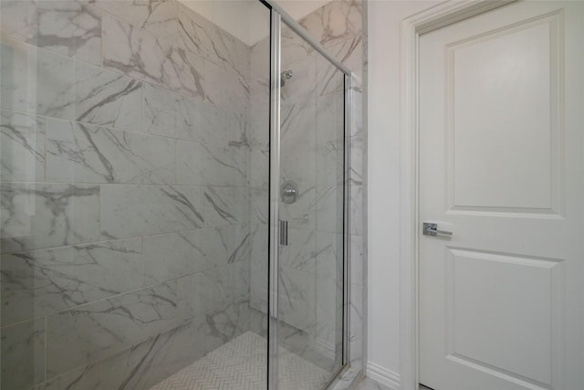 bathroom featuring a shower with shower door