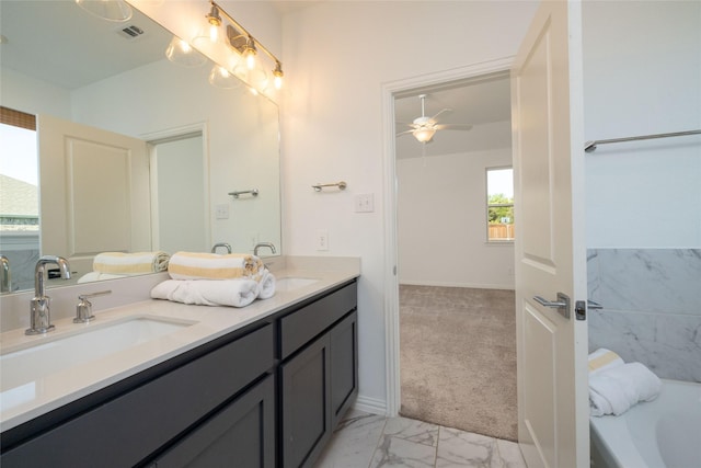 bathroom featuring ceiling fan, vanity, and a bathtub