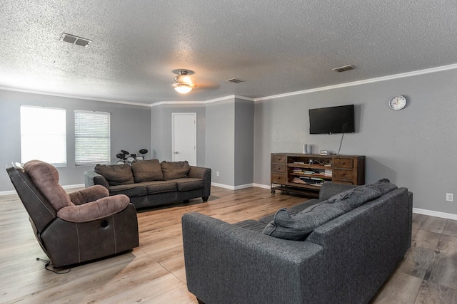 living room with ornamental molding, a textured ceiling, ceiling fan, and light hardwood / wood-style floors