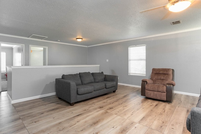 living room with a textured ceiling, ceiling fan, ornamental molding, and hardwood / wood-style flooring