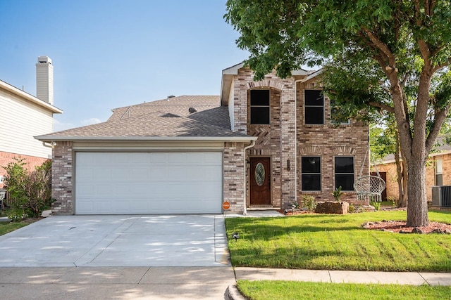 view of front of house featuring cooling unit, a garage, and a front lawn