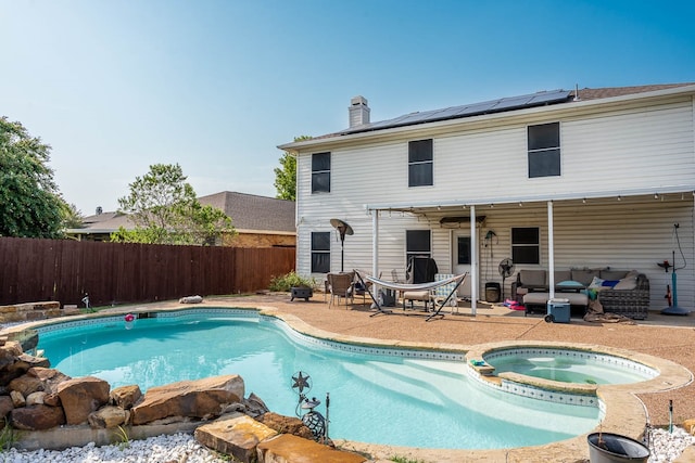 view of swimming pool featuring an outdoor hangout area, a patio area, and an in ground hot tub