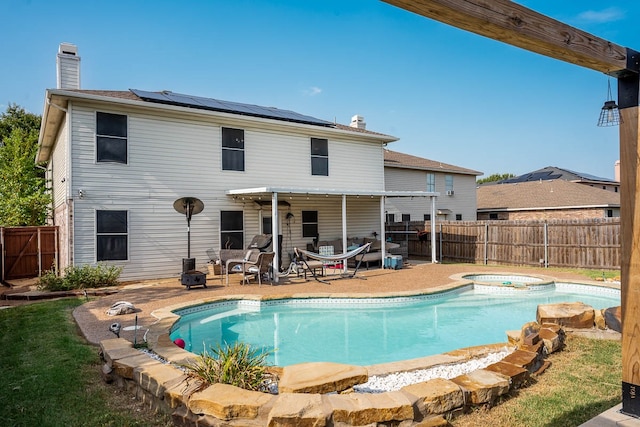 view of pool featuring a patio and an in ground hot tub