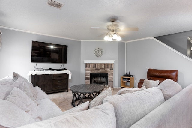 living room featuring a textured ceiling, crown molding, ceiling fan, and light tile patterned flooring