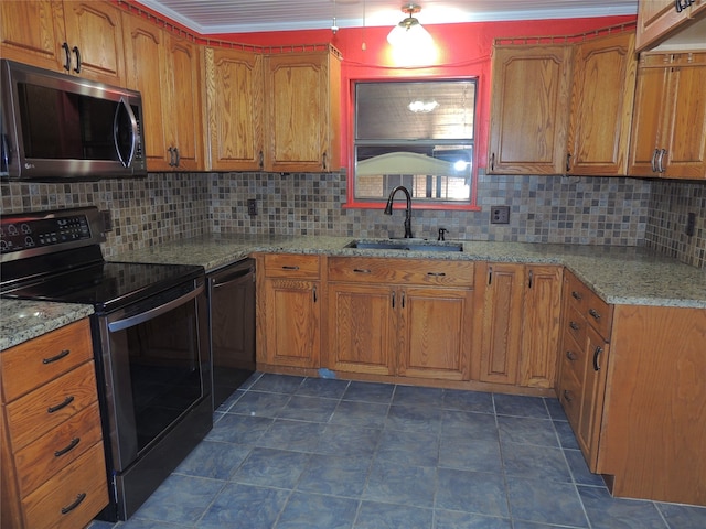 kitchen featuring black appliances, backsplash, light stone countertops, and sink