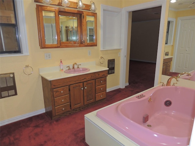 bathroom with vanity, ornamental molding, and a tub to relax in