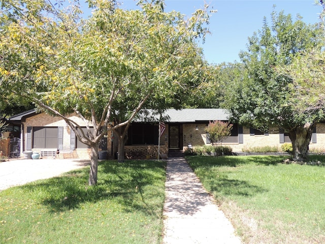 view of front of property with a front yard and a garage