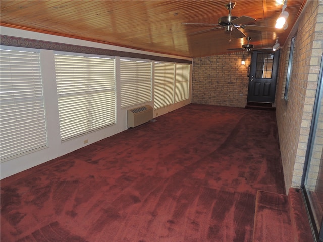 unfurnished sunroom featuring radiator heating unit, ceiling fan, lofted ceiling, and wood ceiling