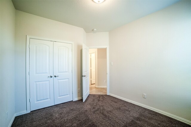 unfurnished bedroom featuring a closet and carpet flooring