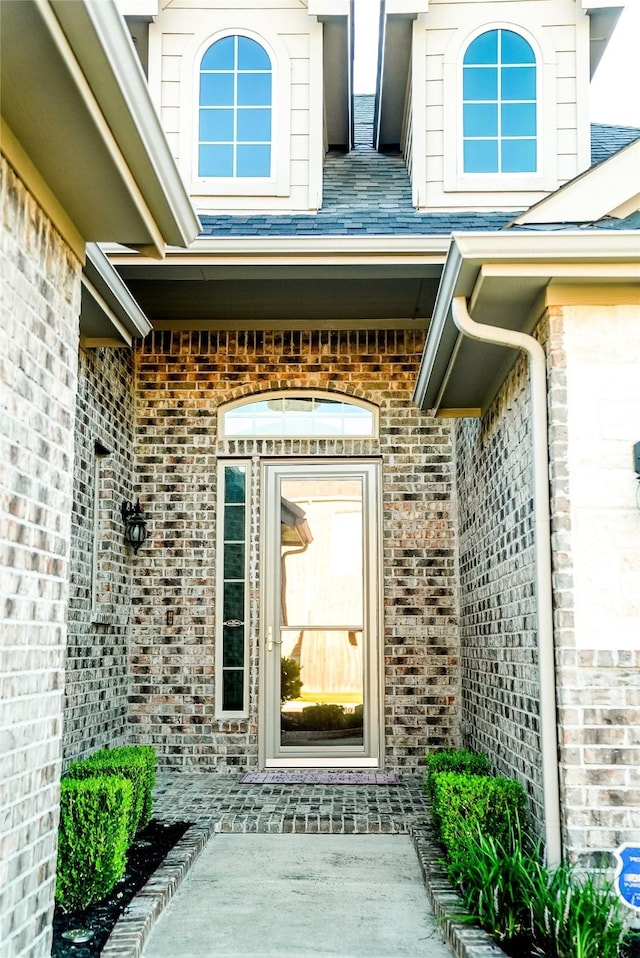 property entrance featuring brick siding