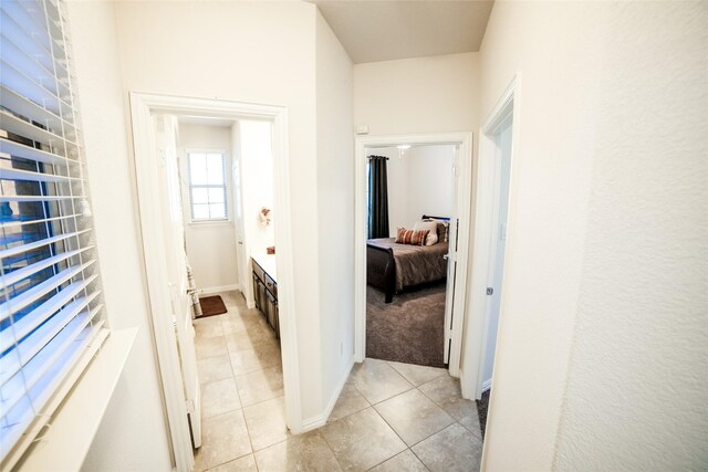 hallway with light tile patterned floors