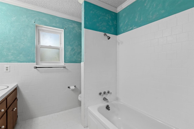 bathroom featuring vanity, toilet, tile walls, and a textured ceiling