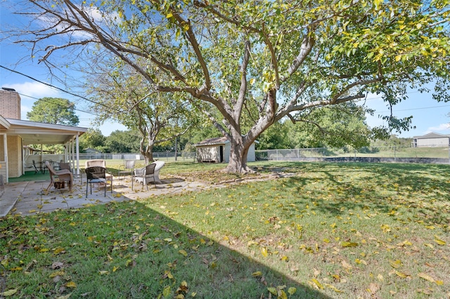 view of yard with a shed and a patio