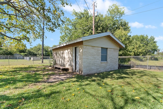 view of outbuilding with a lawn