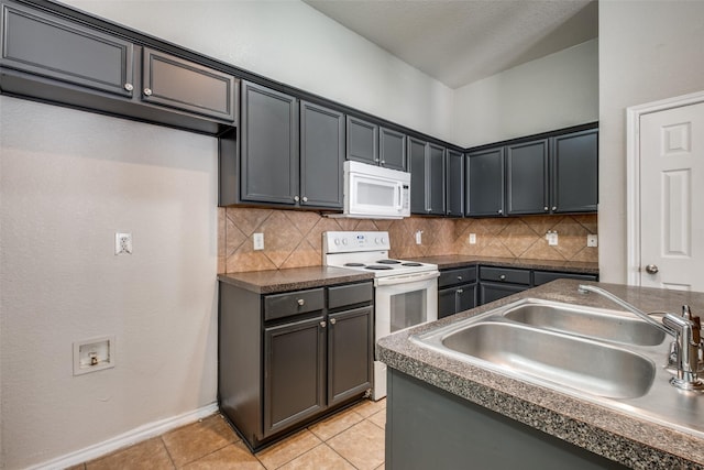 kitchen with sink, white appliances, tasteful backsplash, and light tile patterned flooring