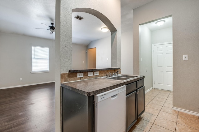 kitchen with dishwasher, sink, light hardwood / wood-style flooring, ceiling fan, and dark brown cabinetry