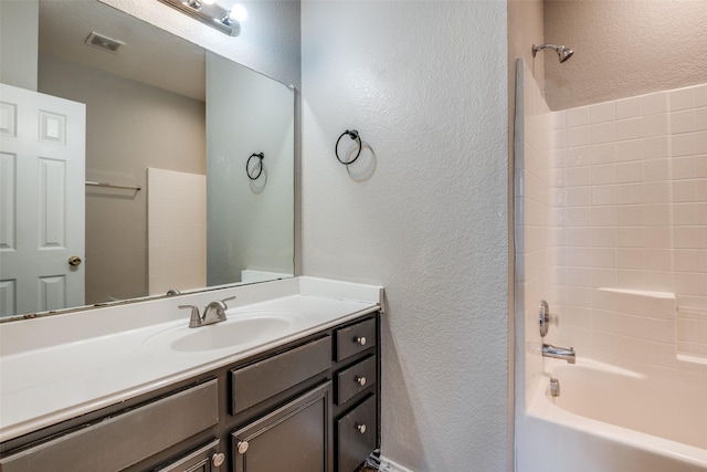 bathroom with vanity and washtub / shower combination