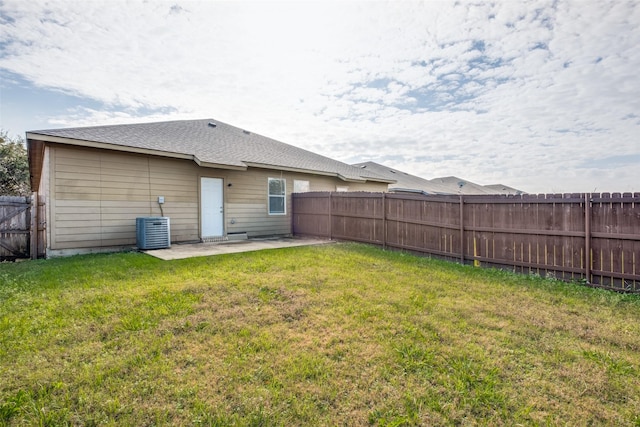 rear view of house with a lawn and a patio