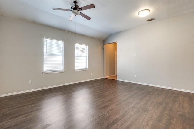 empty room with dark hardwood / wood-style flooring, ceiling fan, and lofted ceiling